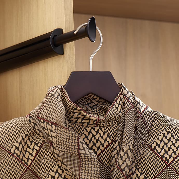 Customized closet accessory racks and storage for shoe designed for a walk in closet with LED lighting accents by California Closets