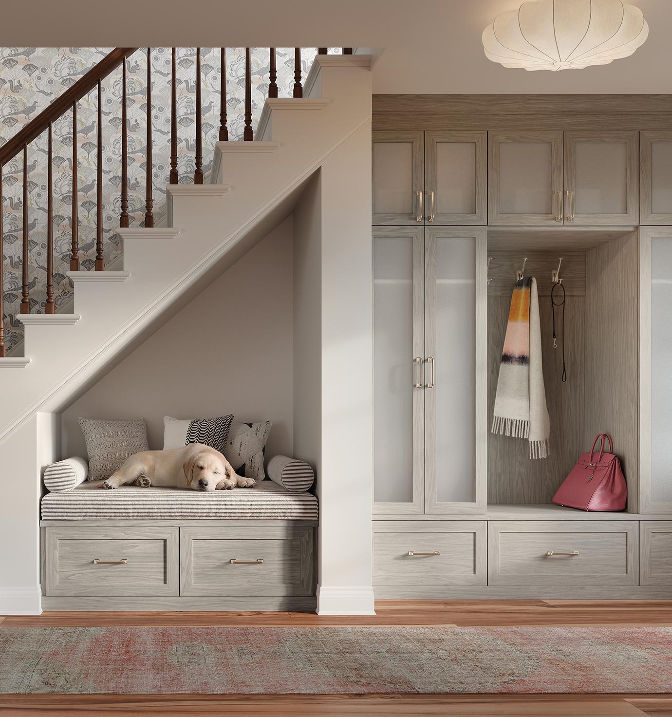 Entryway storage system with a bench, built in drawers, and light grain cabinets by California Closets