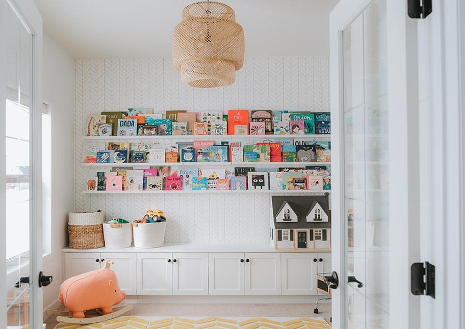 Kids playroom with bookshelves, drawers, shelving by California Closets