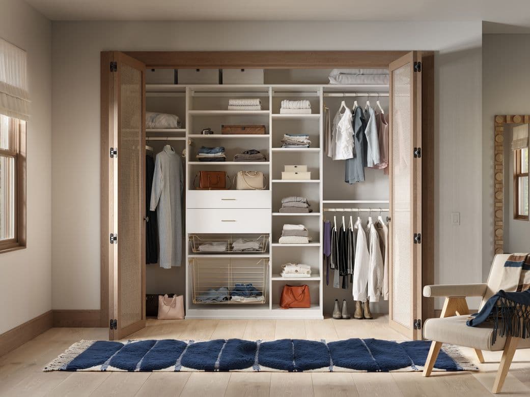 Teens reach in closet floor to ceiling storage shelves and drawers by California Closets