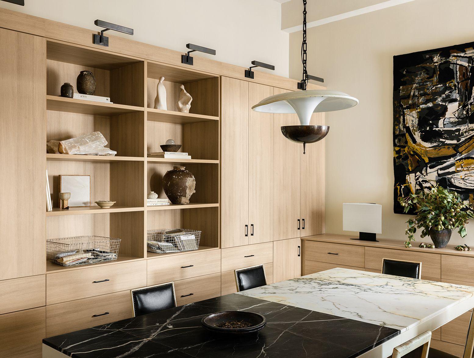 Jeremiah Brent's home office with light finish cabinetry, open shelving, and customized drawers for fabrics by California Closets