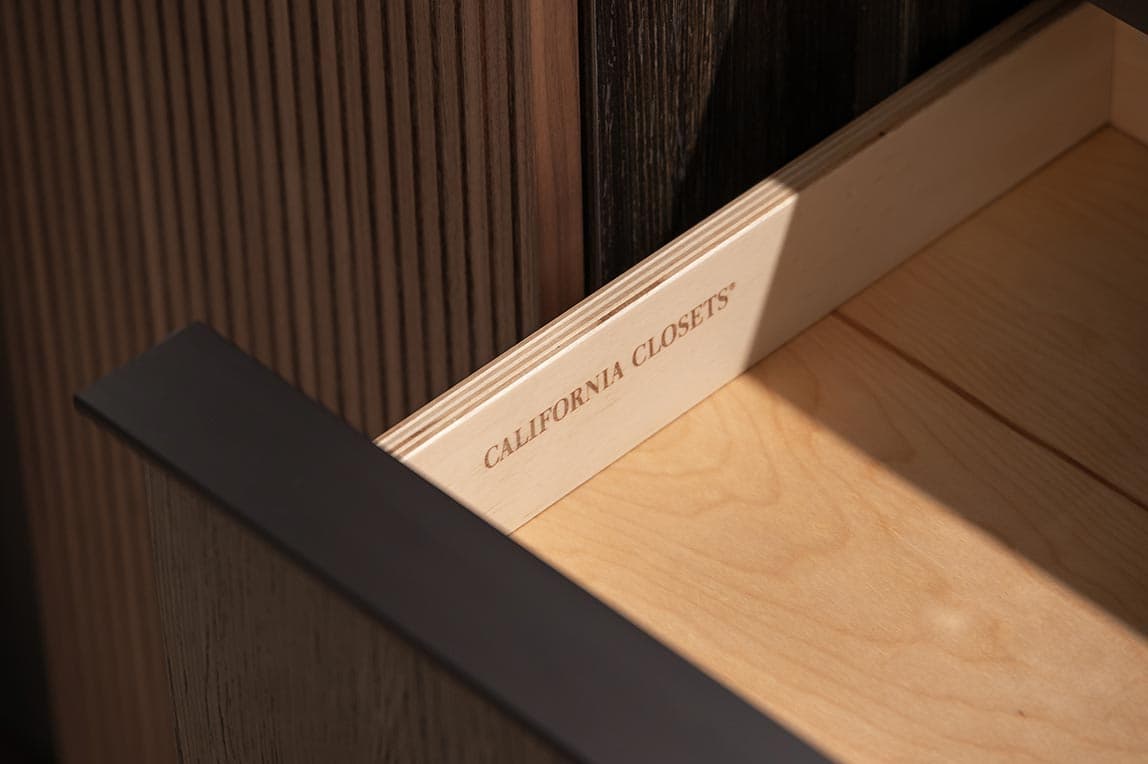 Dark wood finish with cabinet drawers with soft-close California Closets