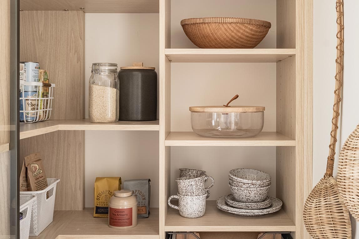 Corner pantry design with corner shelving and wrap shelves made by California Closets