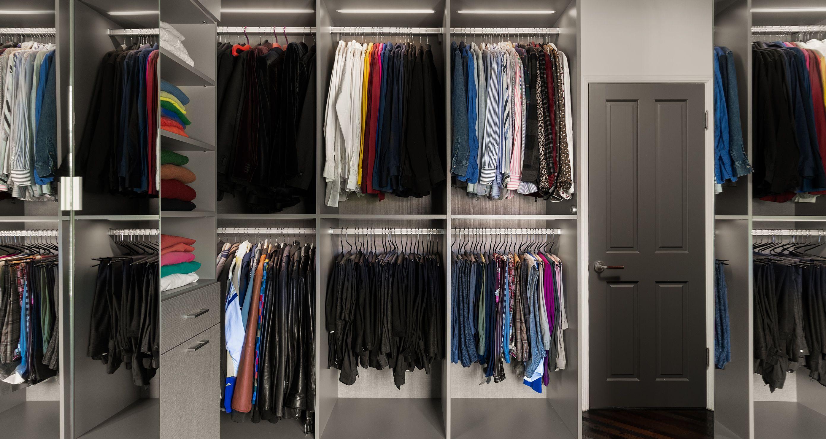 Walk in closet designed for Brad Goreski with floor to ceiling wardrobe storage by California Closets