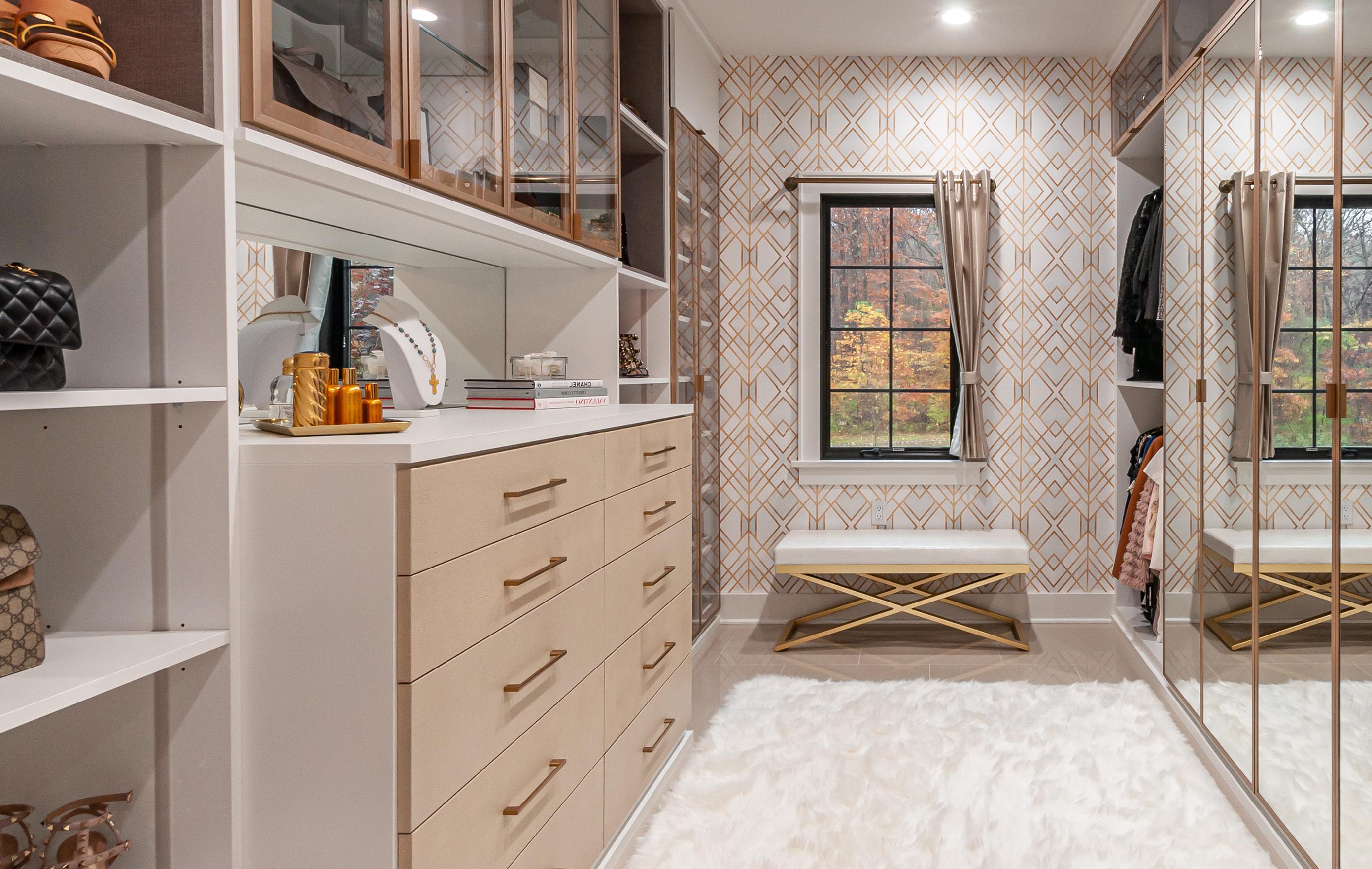 Master bedroom walk in closet designed for couple's New Jersey home by California Closets