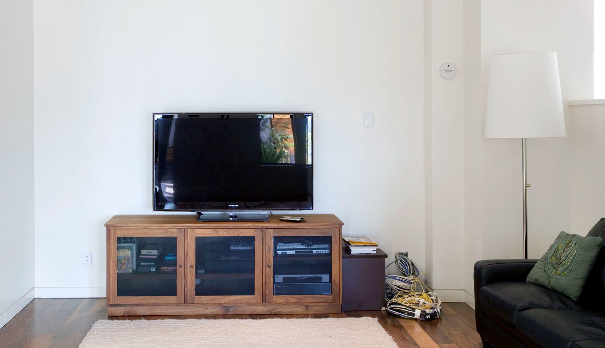Media center with custom organizers and cabinets by California Closets